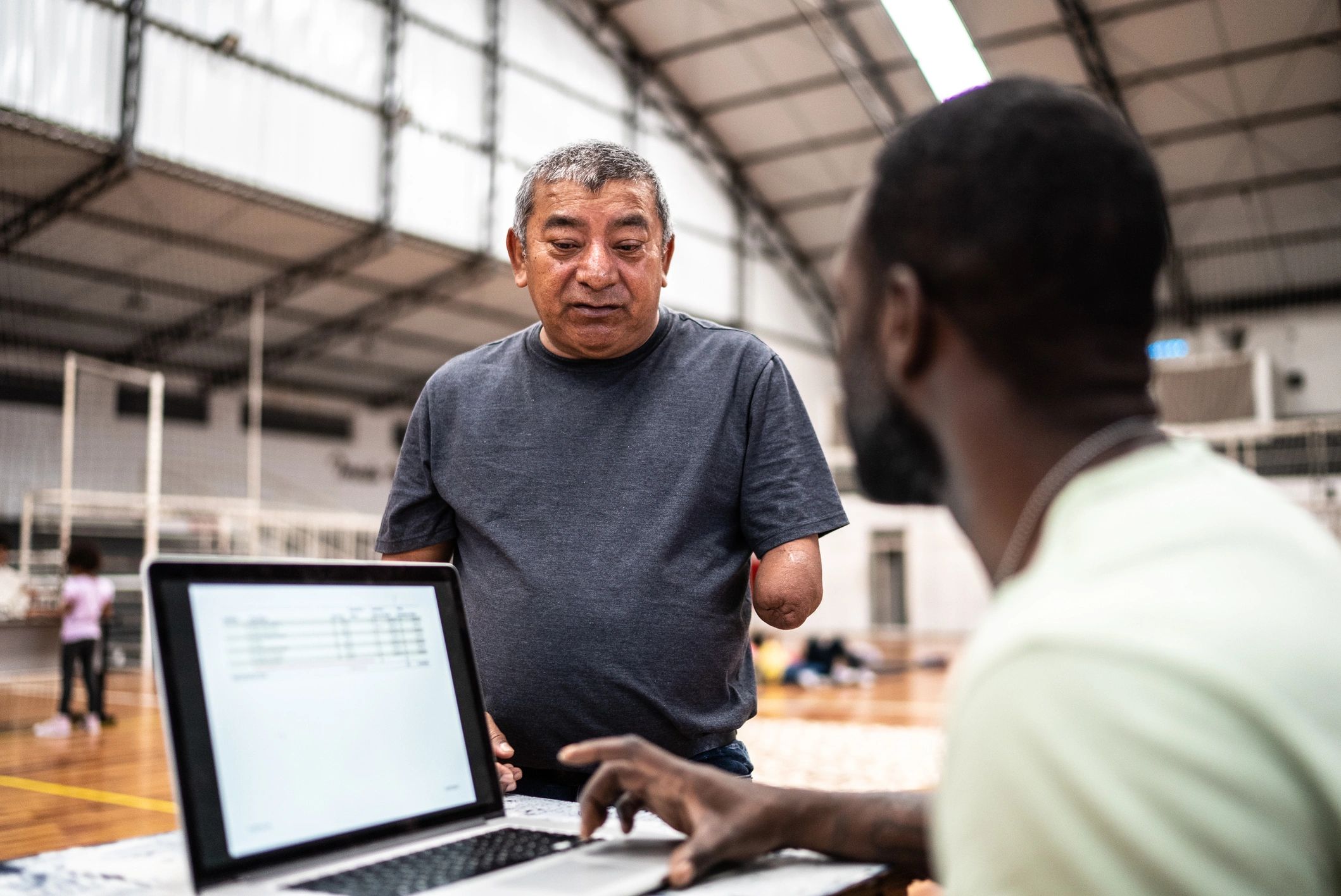 One-on-one laptop help session at a community center
