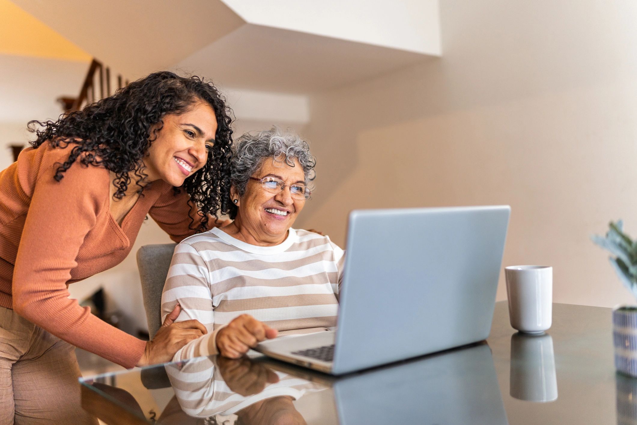 Senior receiving patient laptop help at home